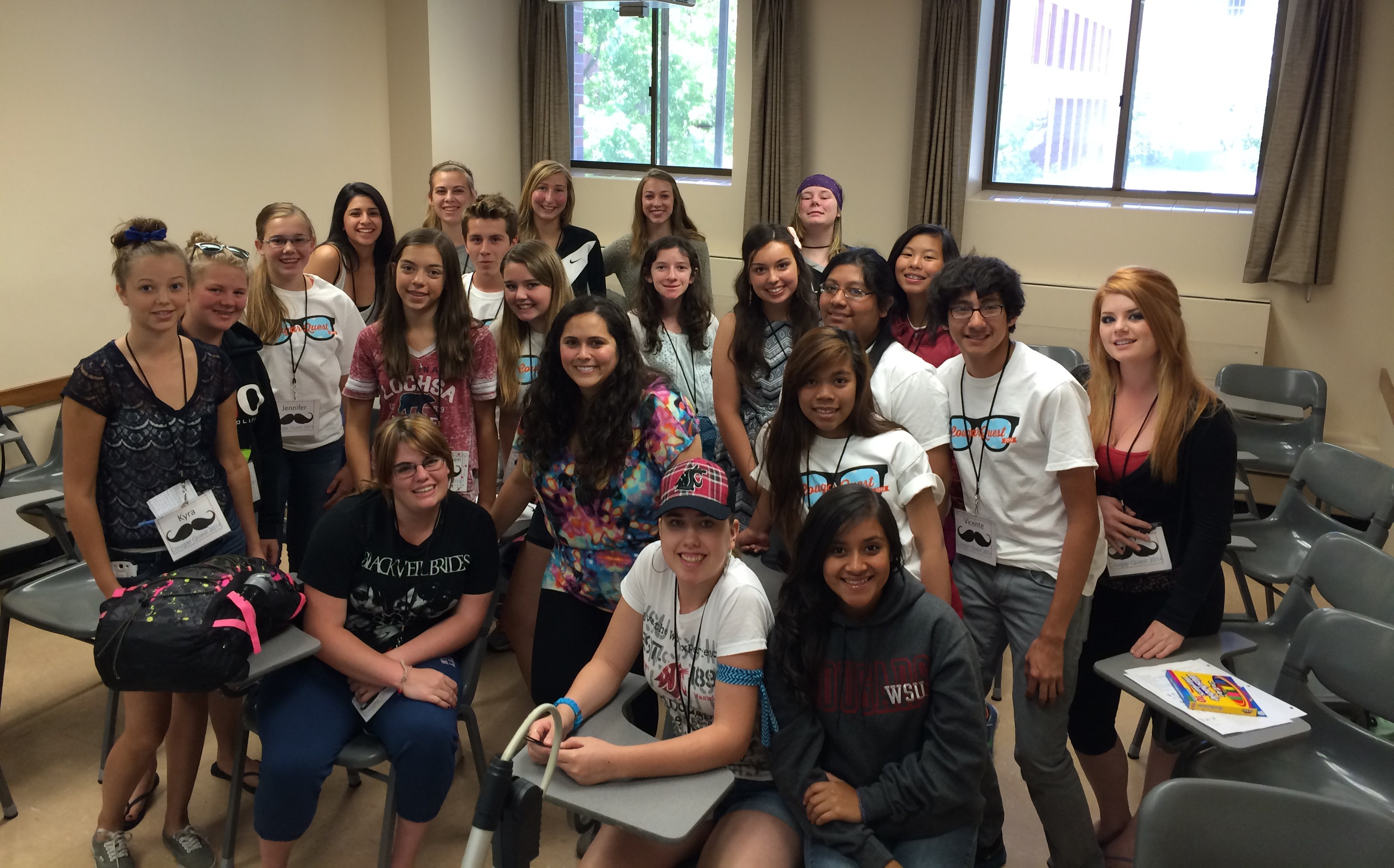 Photo of Davi in the middle of a classroom surrounded by students.